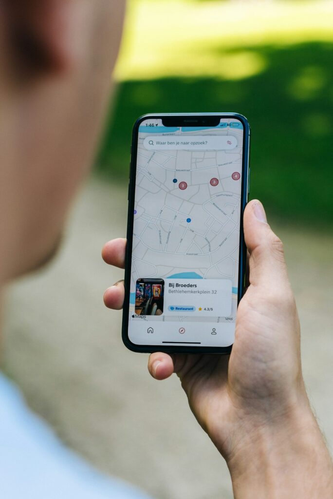 Hand holding a smartphone used for mobile travel connectivity